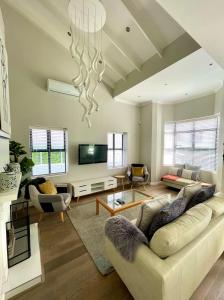 a living room with a couch and a tv at Atlantic Cove in Cape Town