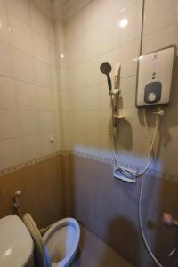 OYO 93202 Pentagon Homestay Syariah في سورابايا: حمام صغير مع مرحاض ودش