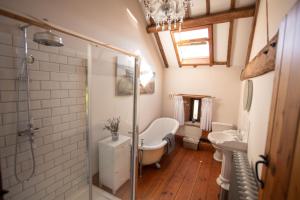 a bathroom with a shower and a sink at The Threshing Barn in Woodhall Spa +45 photos
