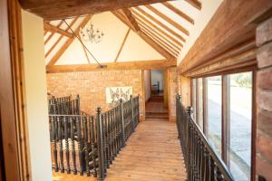an internal view of a house with a wooden walkway at The Threshing Barn in Woodhall Spa