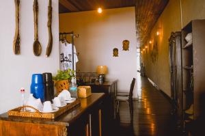 a kitchen with a counter and a table and chairs at Pousada Beija Flor in Salvador