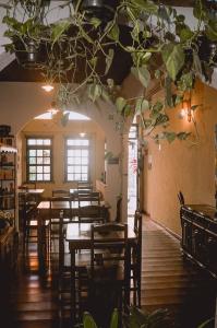 a restaurant with tables and chairs in a room at Pousada Beija Flor in Salvador