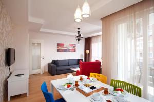 a living room with a white table and chairs at The Room Hotel & Apartments in Antalya