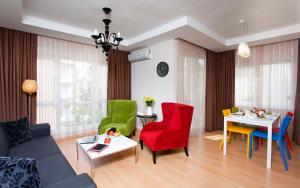 a living room with colorful chairs and a table at The Room Hotel & Apartments in Antalya