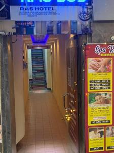 a hallway in a building with signs on the wall at RAS International Hotel in Kuala Lumpur