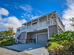 a large white house with a large balcony at Sea Blue Heaven in Tutukaka
