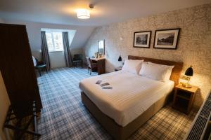 a hotel room with a bed and a desk at The Ripon Inn - The Inn Collection Group in Ripon
