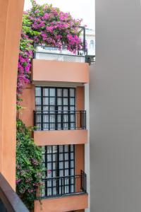 an apartment building with flowers on the balconies at The Red Pier by Downtown Udaipur in Udaipur