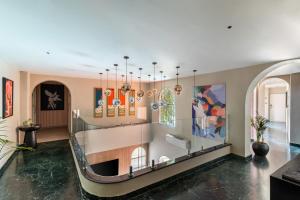 a room with glass shelves with artwork on the wall at The Red Pier by Downtown Udaipur in Udaipur