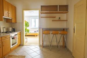 a kitchen with a counter and stools in it at Central Living Apartments - Schottentor in Vienna
