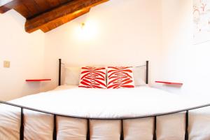 a bedroom with a large white bed with red pillows at Il nido sulla Mole in Turin