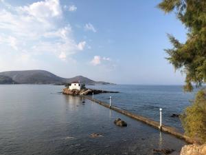 a small island in the middle of a body of water at Villa Omega Guest House in Kokkali, Leros in Gourna