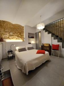 a bedroom with a large bed and a staircase at Casa Vincenti in Orvieto