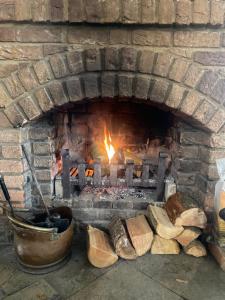 a brick oven with a fire in it at The Berkeley in Peopleton
