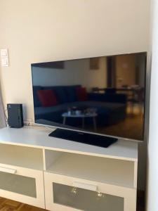 a large flat screen tv sitting on top of a dresser at Lydia's City View Apartment in Ioannina