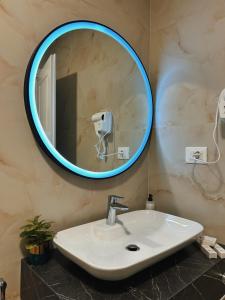 a bathroom with a sink and a mirror at Clinton Tirana Inn in Tirana