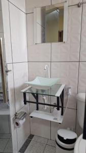 a bathroom with a sink and a toilet at Saymon Hotel in Portel