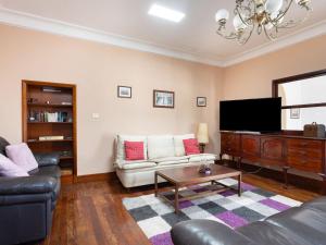 a living room with a couch and a flat screen tv at Holiday Home Barreto by Interhome in Puerto de la Cruz