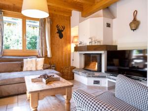 a living room with a couch and a fireplace at Chalet Miranda by Interhome in Champex