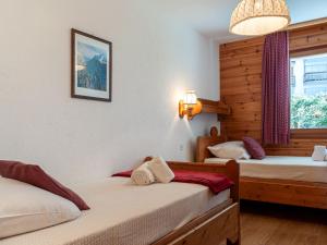 a bedroom with two beds and a window at Apartment Hauts De Nendaz B OP by Interhome in Nendaz