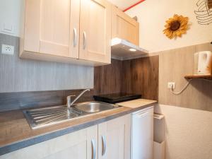 a kitchen with a sink and a counter top at Apartment Le Sarvan-3 by Interhome in Les Menuires