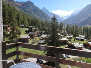 a view from a balcony of a village in the mountains at Studio Les Erables Apt 361 by Interhome in Zinal