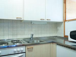 a kitchen with a sink and a microwave at Apartment Christiania 2 L1 by Interhome in Nendaz