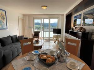 a living room with a table and a couch at Apartment Schwarzwaldblick I by Interhome in Bernau im Schwarzwald