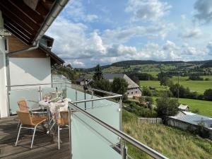 a balcony with a table and chairs and a view at Apartment Schwarzwaldblick I by Interhome in Bernau im Schwarzwald