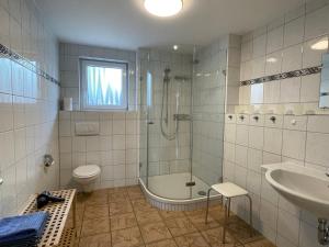 a bathroom with a tub and a toilet and a sink at Apartment Schwarzwaldblick I by Interhome in Bernau im Schwarzwald