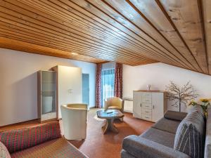 a living room with a wooden ceiling at Apartment Alpenrose Apartment 3 by Interhome in Sankt Urban