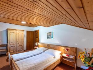 Sankt UrbanにあるApartment Alpenrose - FEK110 by Interhomeの木製の天井が特徴のベッドルーム1室(ベッド2台付)