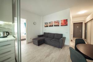 a living room with a couch and a table at COZY APARTHOTEL - Ultracentral Luxury Apartments Iasi in Iaşi