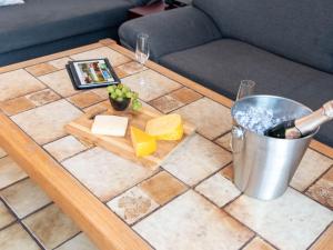 een tafel met kaas en een emmer erop bij Apartment Muschelweg-1 by Interhome in Norddeich