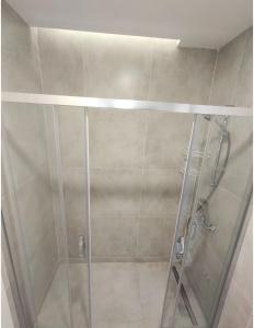 a shower with a glass door in a bathroom at luxury family 2+1 apt in toya next Residence in Istanbul