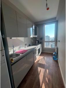 a kitchen with a sink and a large window at luxury family 2+1 apt in toya next Residence in Istanbul