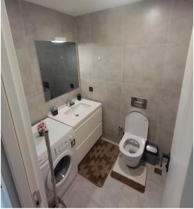 a bathroom with a sink and a toilet and a mirror at luxury family 2+1 apt in toya next Residence in Istanbul