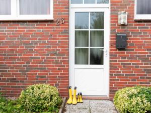 a group of rubber boots sitting in front of a door at Holiday Home Seefalke by Interhome in Norddeich