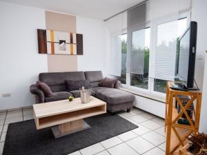 a living room with a couch and a table at Holiday Home Seefalke by Interhome in Norddeich +42 photos