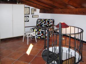 a living room with a chair and a staircase at Apartment Casa del Cavaliere by Interhome in Dolcedo +19 photos