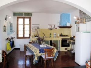 a kitchen with a table and chairs and a refrigerator at Apartment Casa del Cavaliere by Interhome in Dolcedo