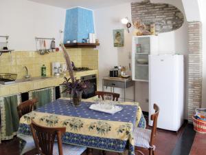 a kitchen with a table and a refrigerator at Apartment Casa del Cavaliere by Interhome in Dolcedo