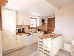 a kitchen with white cabinets and a sink at Holiday Home Le Belvédère by Interhome in Saint-Clair