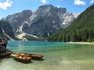 three boats on a lake in front of a mountain at Apartment Plan de Socrep by Interhome in Santa Cristina Gherdëina