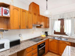 a kitchen with wooden cabinets and a sink at Holiday Home Castilla by Interhome in Miami Platja