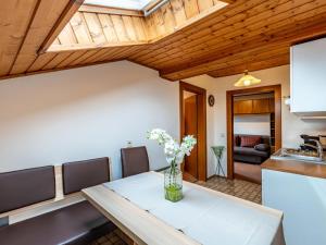 a kitchen and dining room with a table and chairs at Apartment Alpenrose Apartment 4 by Interhome in Dietrichstein