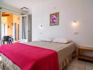 ein Schlafzimmer mit einem großen Bett mit einer roten Decke in der Unterkunft Holiday Home Mistral - REG110 by Interhome in Régusse