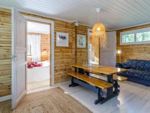 a dining room with a table and a bedroom at Holiday Home Sakarinniemi by Interhome in Kortteinen