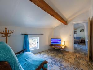 een woonkamer met een bank en een laptop op een tafel bij Holiday Home La Volte by Interhome in Sainte-Croix-de-Caderle