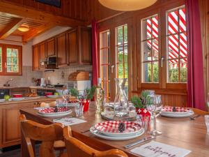 a kitchen with a table with plates and wine glasses at Chalet Bivak by Interhome in Nendaz +34 photos